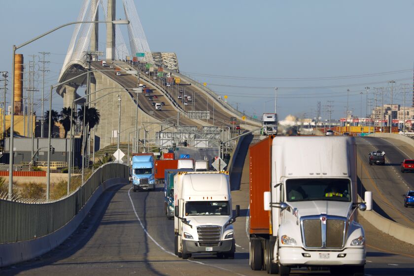 Trucks move across Terminal Island through the ports of Los Angeles and Long Beach in July, 2021.