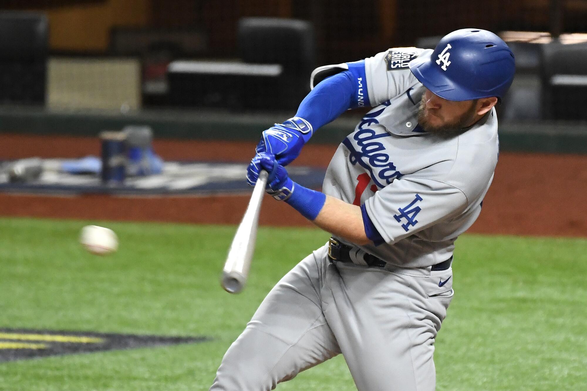 Dodgers first baseman Max Muncy hits a two-run single against the Rays.