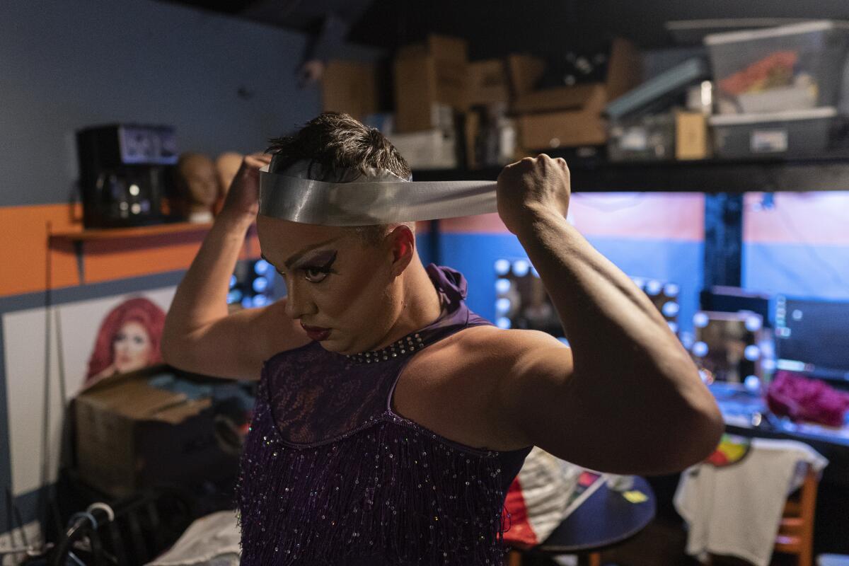 Drag queen Harpy Daniels wraps their hair in duct tape.