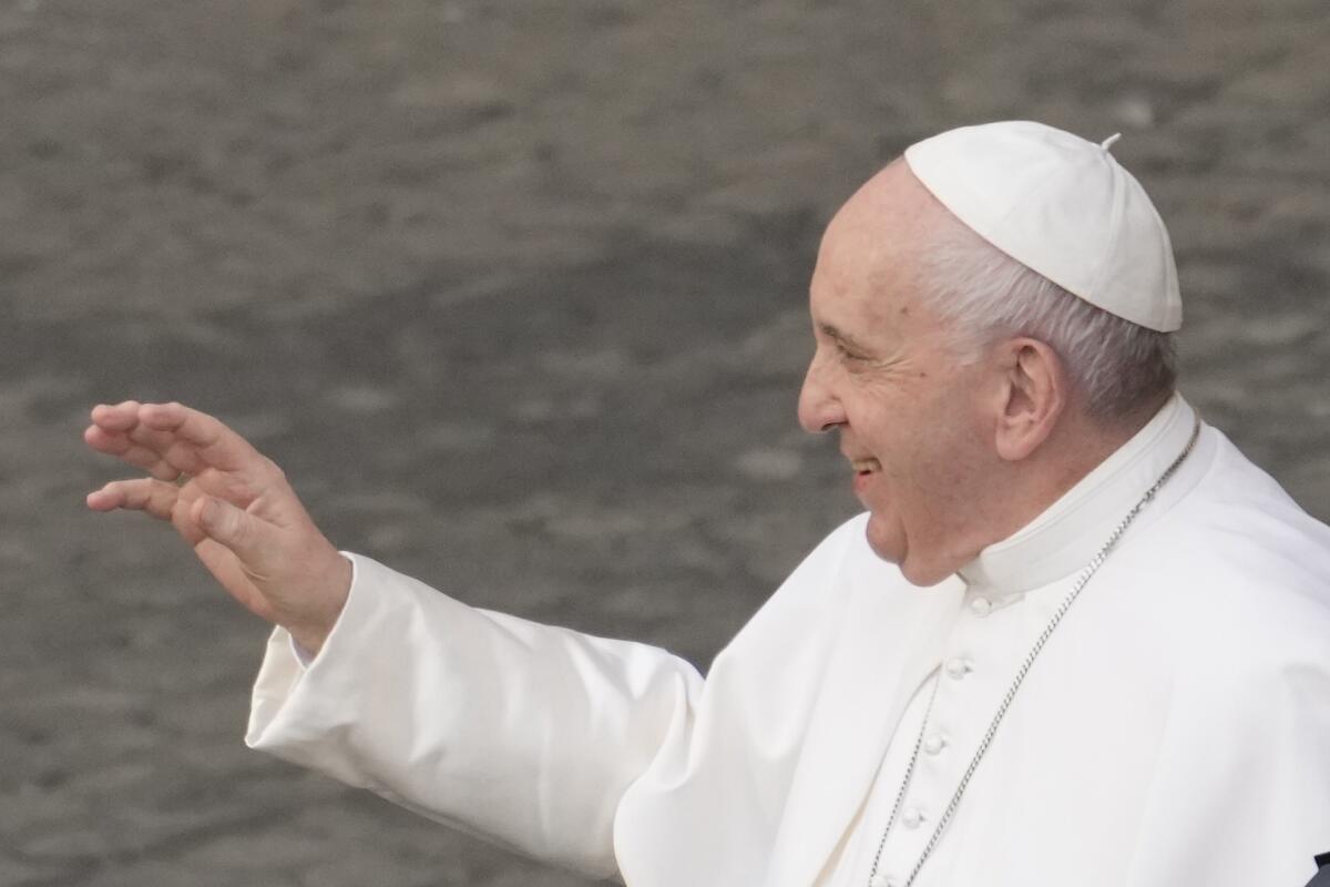 Pope Francis salutes faithful as he arrives for his weekly general audience with a limited number of faithful in the San Damaso Courtyard at the Vatican, Wednesday, June 23, 2021. (AP Photo/Andrew Medichini)