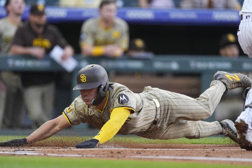 San Diego Padres' Ha-Seong Kim scores on a single by Eguy Rosario off Colorado Rockies starting pitcher Ty Blach during the first inning of a baseball game Wednesday, April 24, 2024, in Denver. (AP Photo/David Zalubowski)