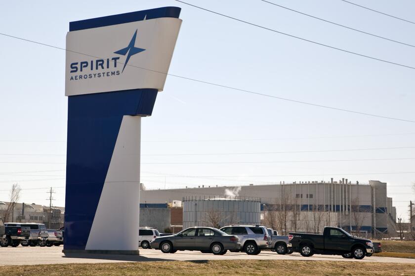 FILE - The Spirit AeroSystems sign is seen, July 25, 2013, in Wichita, Kan. The key Boeing supplier that makes the fuselages for its popular 737 Max airplanes confirmed Thursday, May 16, 2024, that it is laying off about 450 workers because production has slowed down ever since a panel flew off of one of those airplanes operated by Alaska Airlines in midair in January. (Mike Hutmacher/The Wichita Eagle via AP, File)