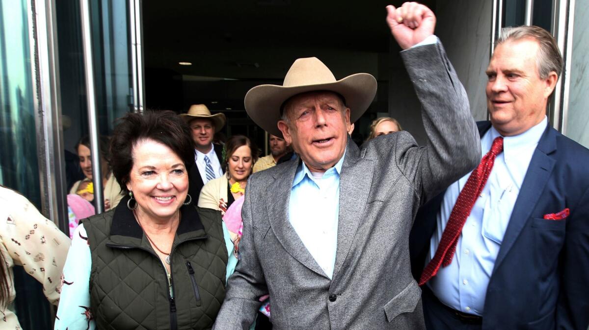 Cliven Bundy walks out of federal court in Las Vegas with his wife Carol on Jan. 8.