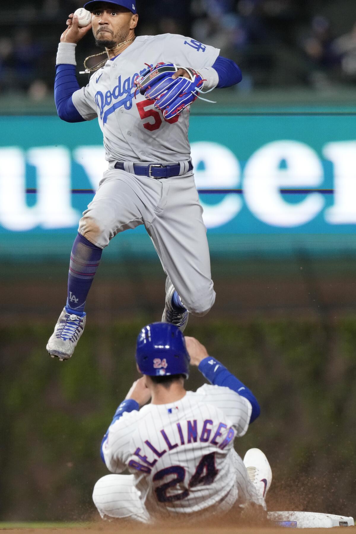 Dodgers shortstop Mookie Betts throws out Chicago Cubs third baseman Patrick Wisdom forces out Cody Bellinger.