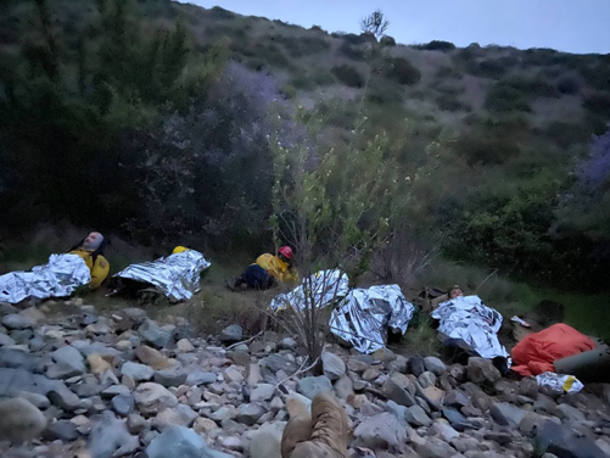 Cal Fire firefighters and Border Patrol agents stayed with an injured woman overnight in cold weather.