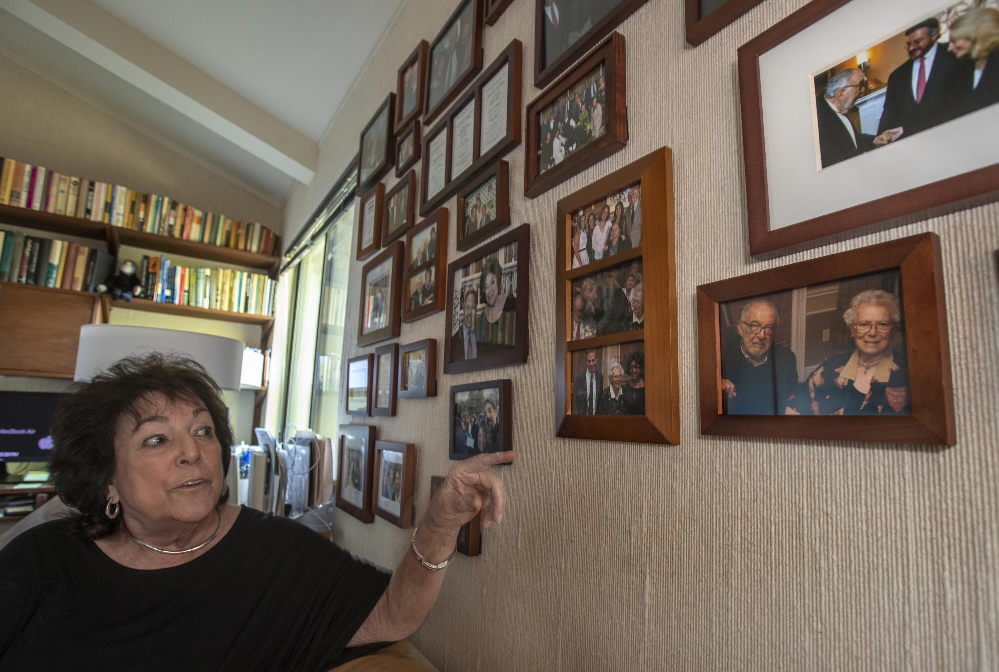 Alice Lynn points to a photograph of social activists Stanley and Betty Sheinbaum, lower right, on the "memory wall"
