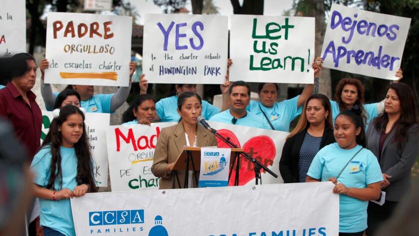 Maria Silva, a parent of a charter school graduate, speaks to parents and charter school supporters during a rally in front of Huntington Park City Hall to protest a moratorium on new charter schools, that the city council plans to vote on Tuesday evening
