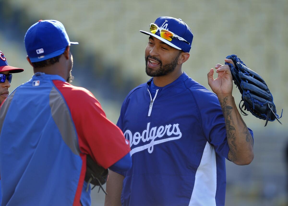Dodgers outfielder Matt Kemp talks with Chicago Cubs players prior to a game in August.