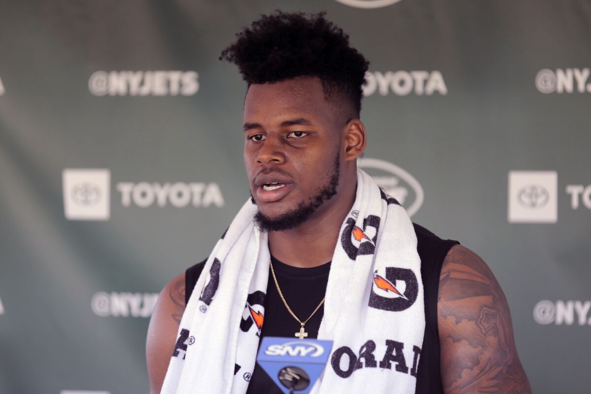 FILE - In this Thursday, July 25, 2019, file photo, New York Jets tight end Chris Herndon speaks to reporters after a practice at the NFL football team's training camp in Florham Park, N.J. Herndon's first five games have been filled with drops, diminished playing time and doubts. (AP Photo/Seth Wenig, File)