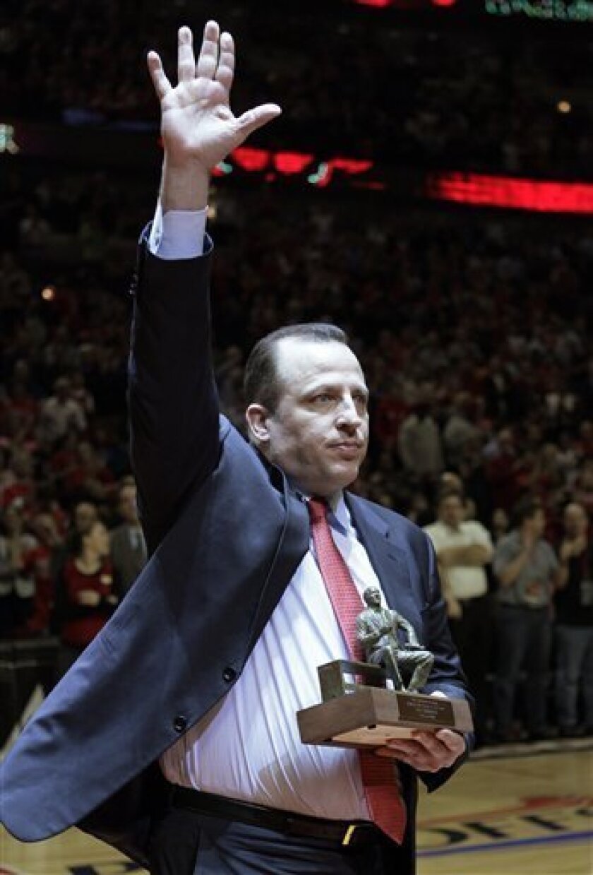 Chicago Bulls coach Tom Thibodeau waves to fans as he holds the Red Auerbach Trophy before the Bulls faced the Atlanta Hawks in Game 1 of a second-round playoff series Monday, May 2, 2011, in Chicago. Thibodeau was named NBA basketball coach of the year on Sunday. (AP Photo/Nam Y. Huh)