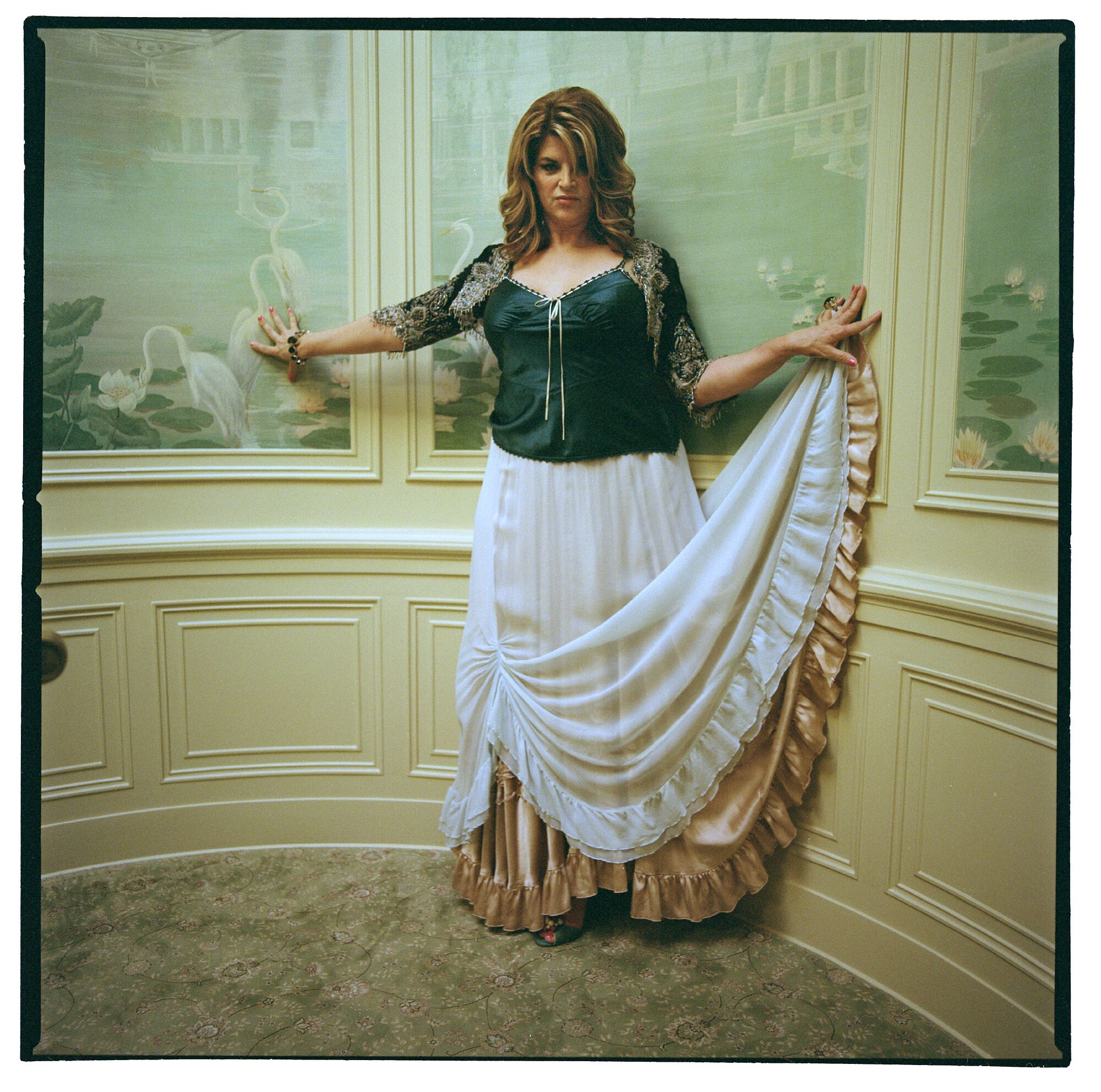Kirstie Alley poses in a long dress.