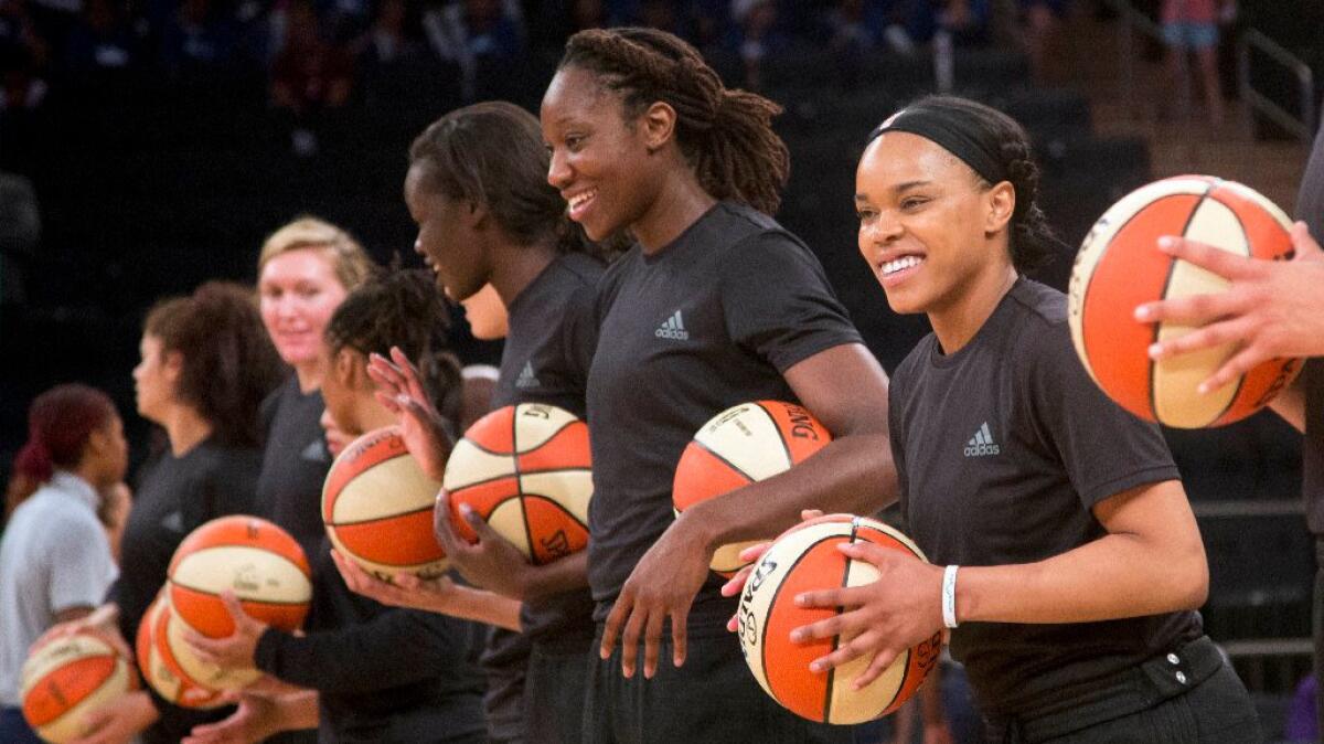Members of the New York Liberty wear black warmup jerseys before the start of a game on July 13.