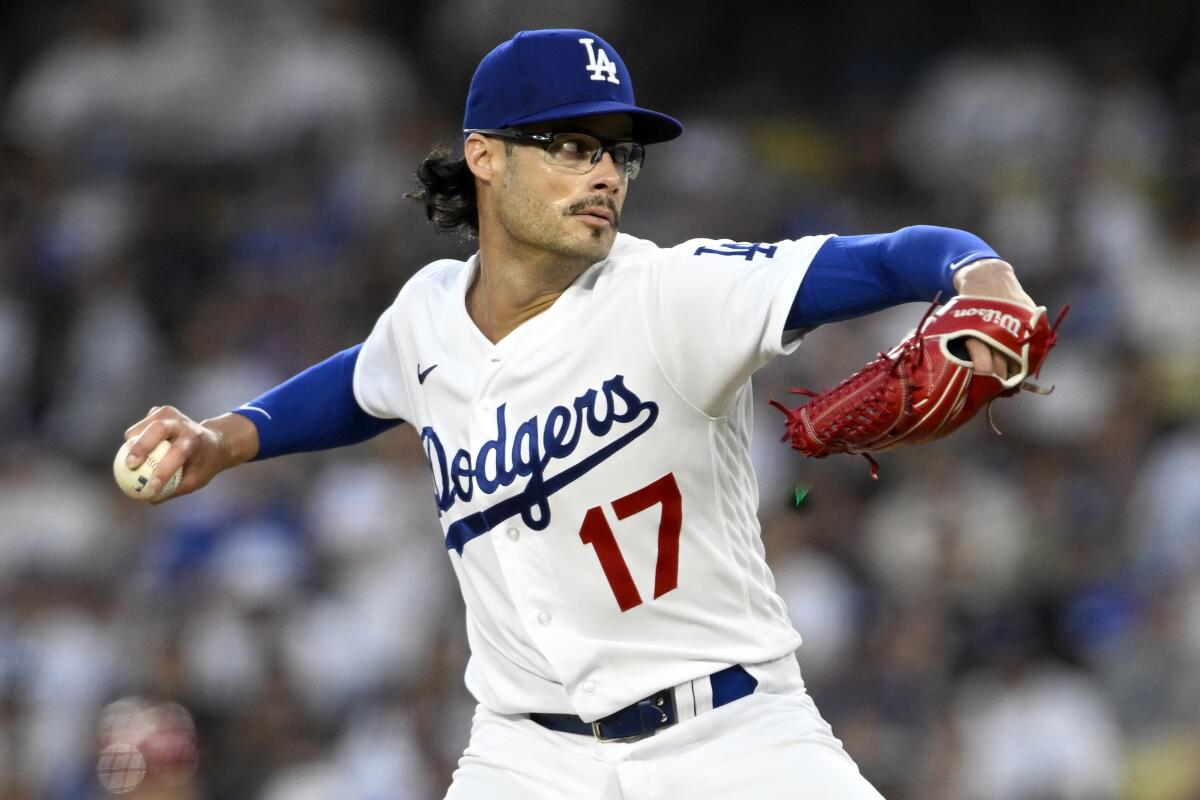 Dodgers relief pitcher Joe Kelly delivers against the Reds.