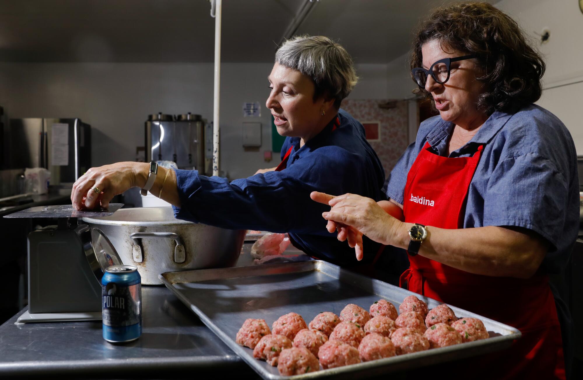 Two people make meatballs in the kitchen of L.A.'s oldest Italian Club, the Garibaldina Society.