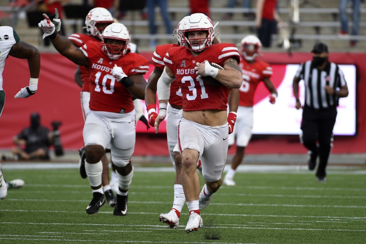 Houston defensive lineman Derek Parish (31) runs back a fumble for a touchdown during the second half of an NCAA college football game against South Florida, Saturday, Nov. 14, 2020, in Houston. (AP Photo/Eric Christian Smith)