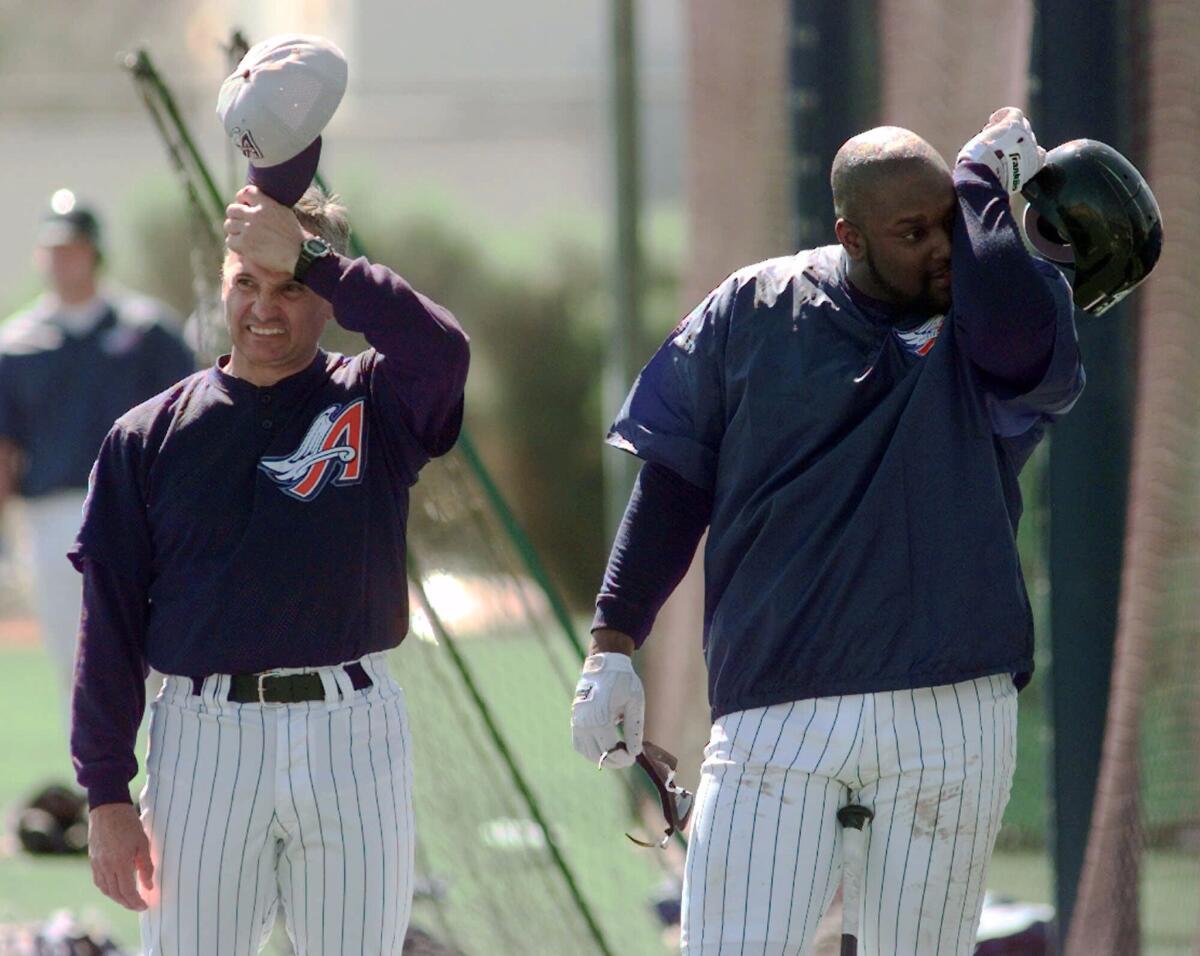 Anaheim Angels Manager Terry Collins and first baseman Mo Vaughn both scratch their heads in 1999.