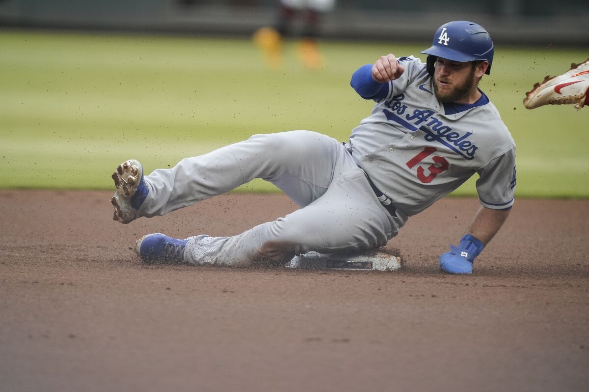 Max Muncy slides into second base being after being forced out on a double play.