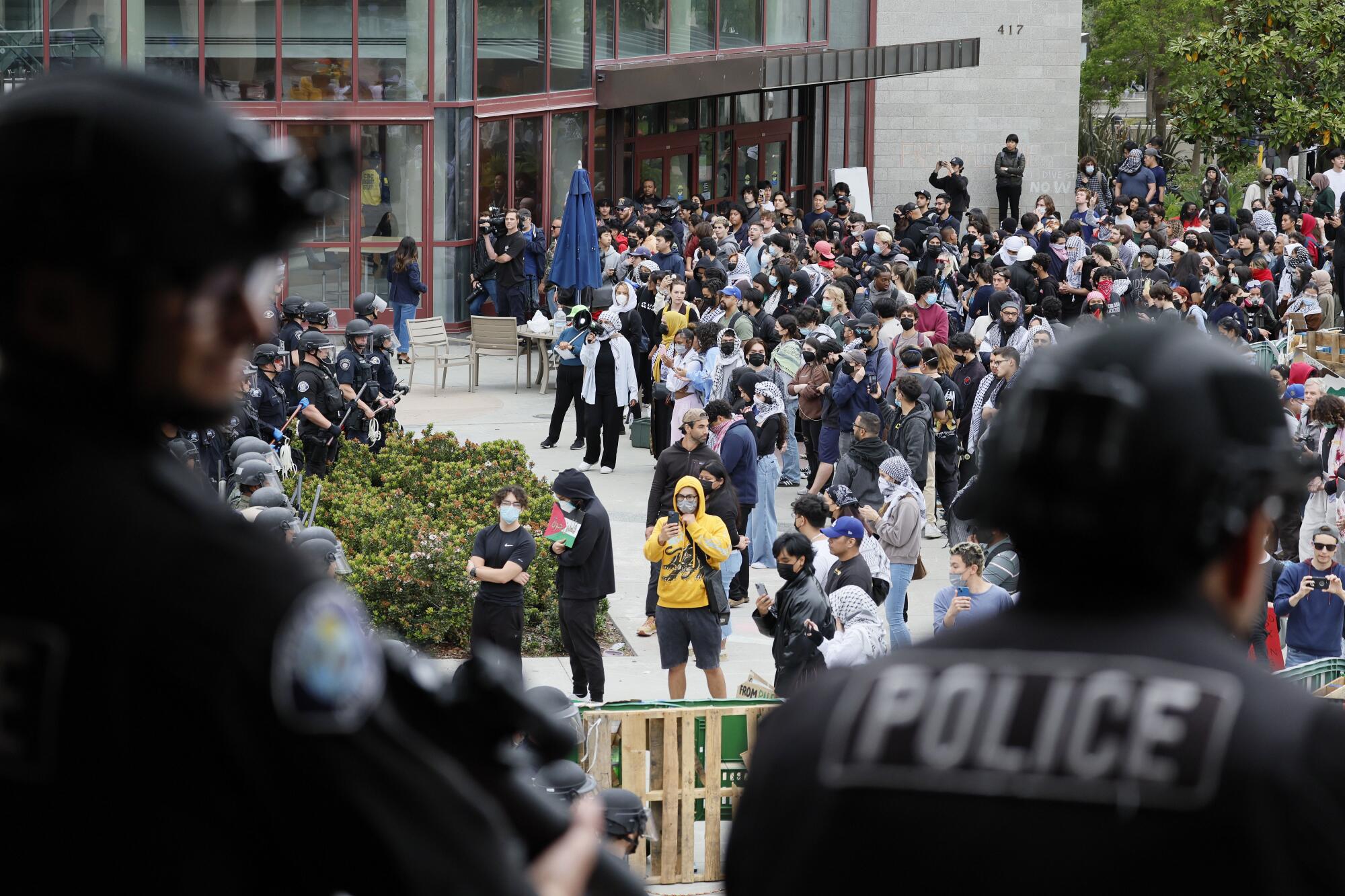 Law enforcement from multiple agencies monitor protesters at ICU on May 15, 202
