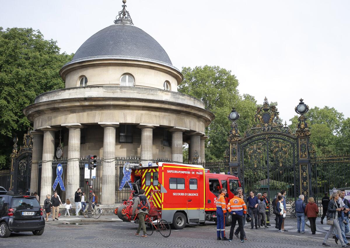 A firetruck is parked at the entrance to Park Monceau in Paris on Saturday, May 28, 2016, where a group of 11 people, many of them children, was struck by lightning.