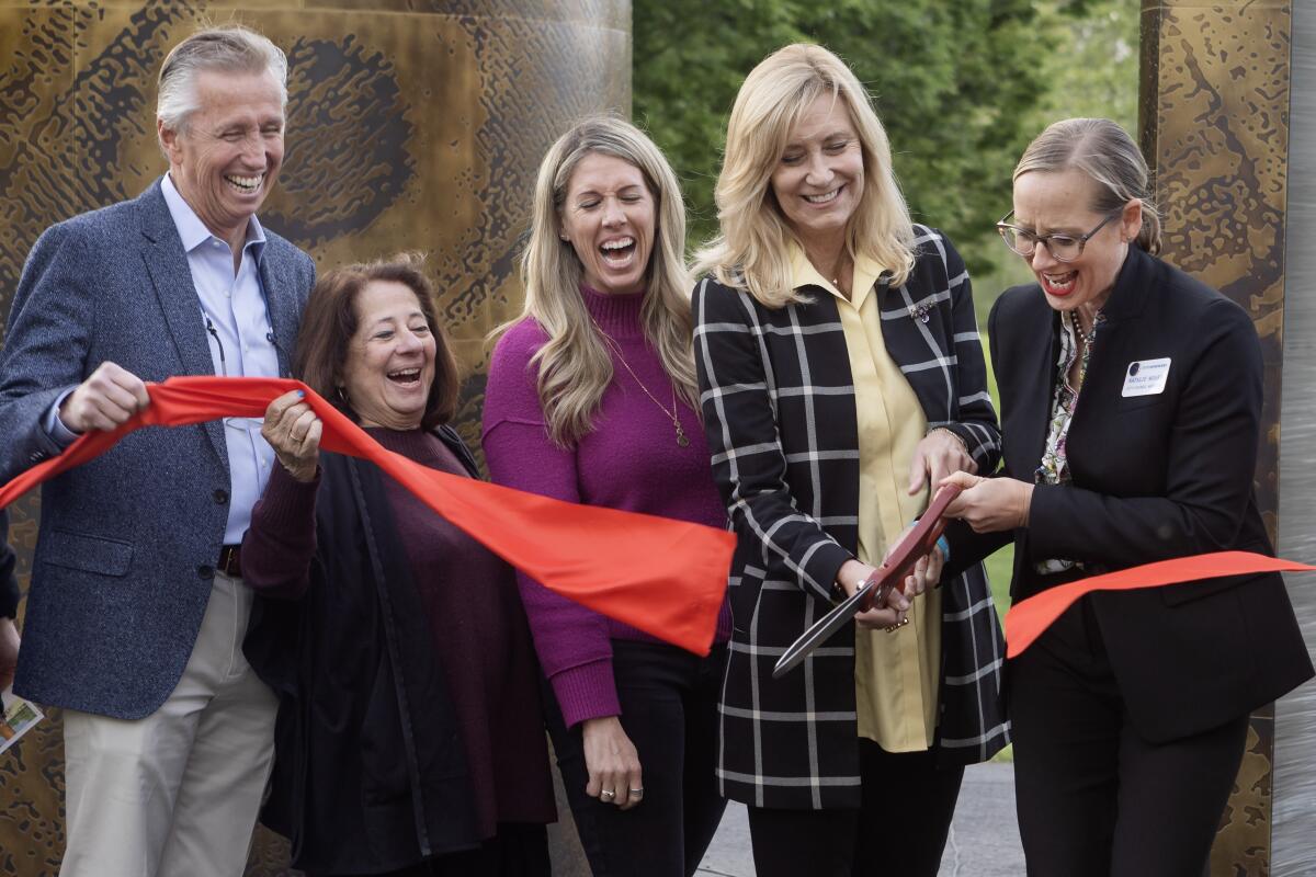 City Councilwoman Natalie Moser and former Mayor Lyn Semeta cut a ribbon.