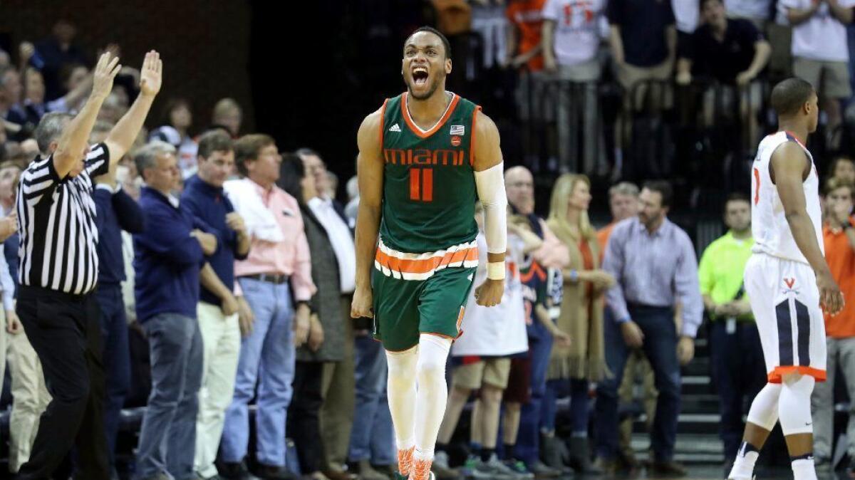 Miami guard Bruce Brown (11) celebrates making a three-point shot during overtime of a game against Virginia on Feb. 20.