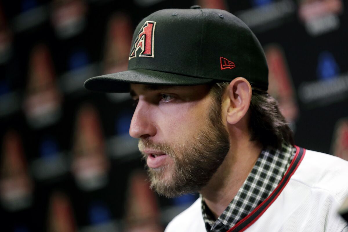 Newly acquired Arizona Diamondbacks pitcher Madison Bumgarner speaks after being introduced during a team availability, Tuesday, Dec. 17, 2019, in Phoenix.
