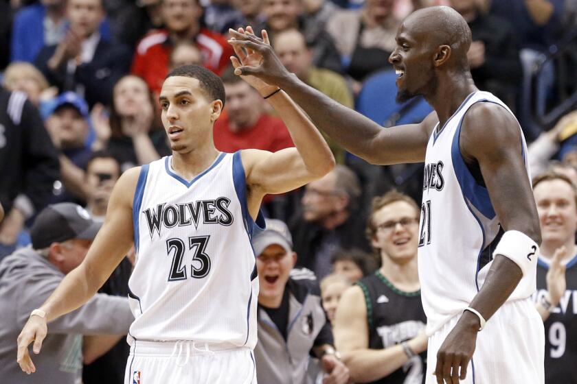 Minnesota guard Kevin Martin and forward Kevin Garnett, left, celebrate after a basket in the second half of the Timberwolves' 97-77 win Wednesday over the Washington Wizards.
