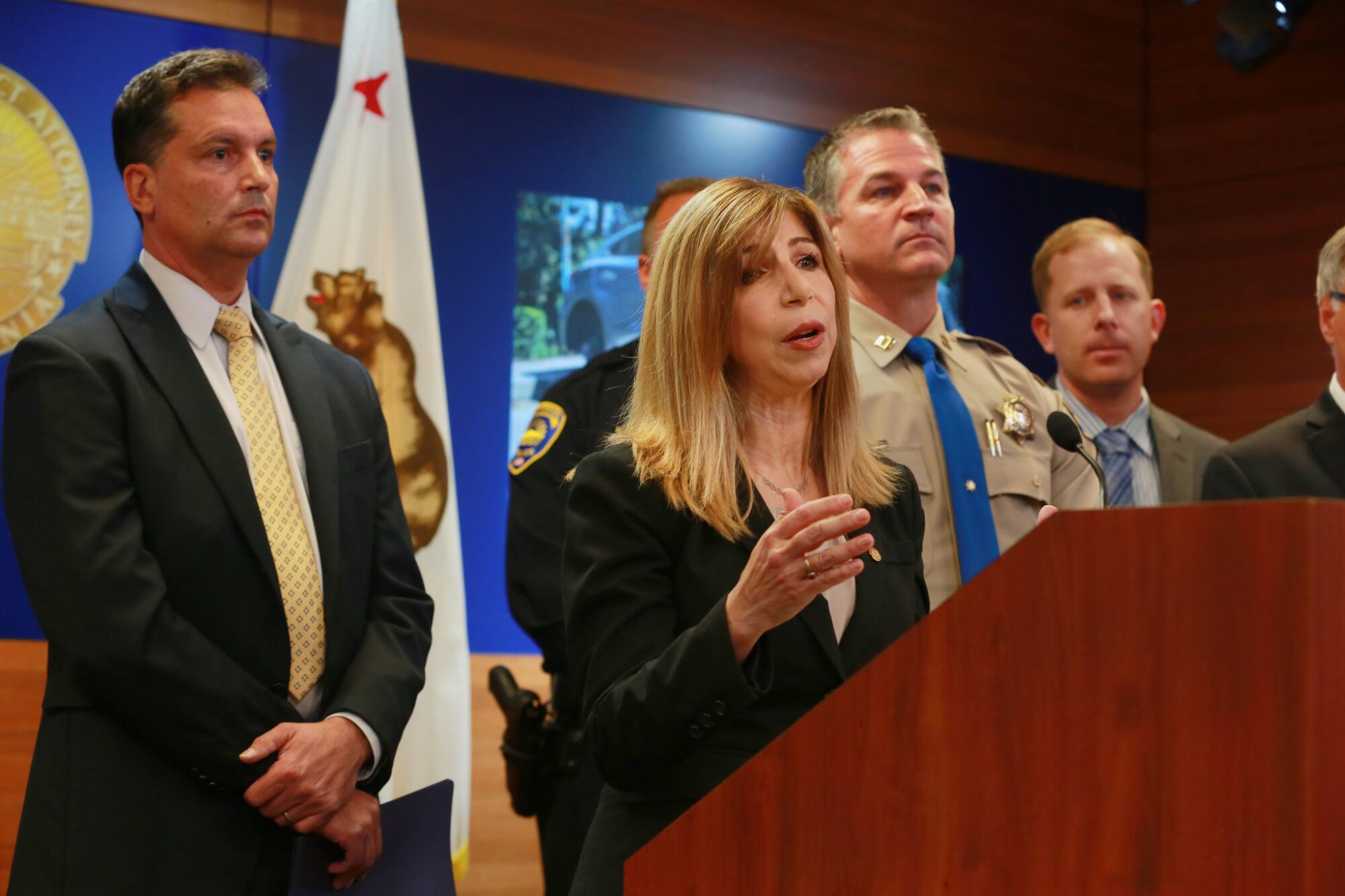 San Diego, CA. USA December 01, 2016 | At the podium Thursday, Deputy District Attorney Summer Stephan introduces the results of an undercover investigation in which detectives bought stolen vehicles, drugs and weapons. At left is Special Agent-in-Charge John D'Angelo of Alcohol, Tobacco and Firearms, and to the immediate right of Stephan is California Highway Patrol Captain Don Goodbrand, the RATT Commander. The Regional Auto Theft Team (RATT), in cooperation with the La Mesa Police Department, San Diego County Sheriff's Department, the California Highway Patrol and the Bureau of Alcohol, Tobacco and FIrearms, conducted a 10-month undercover operation that resulted in 42 grand jury indictments. The defendants face various felony charges including vehicle theft, identity theft, illegal weapons possession and illegal drug possession and sales. Operation Kwik Boost was launched in January of this year and netted 117 stolen cars valued at $1.3 million, 51 firearms, five and a half pounds of methamphetamine, three kilos of cocaine and 15 pounds of marijuana. | Mandatory photo credit: Peggy Peattie / San Diego Union-Tribune