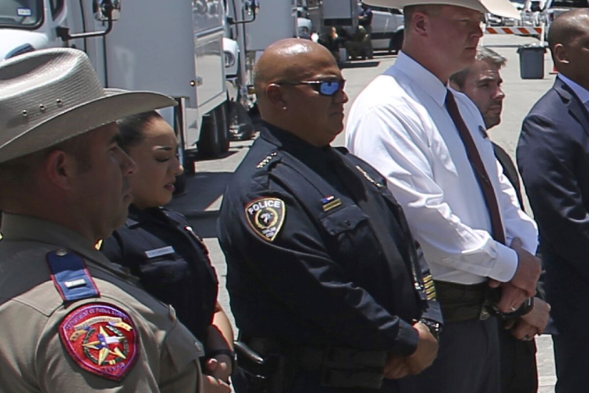 In this May 26, 2022, photo, Uvalde School Police Chief Pete Arredondo, third from left, stands during a news conference outside of the Robb Elementary school in Uvalde, Texas. Facing massive public pressure, Uvalde’s top school official has recommended the firing of the school district police chief who was central to the botched law enforcement response to the shooting at an elementary school that killed two teachers and 19 students. The city’s school board will consider firing Arrendondo at a special meeting Saturday, July 23, to consider the superintendent's recommendation. (AP Photo/Dario Lopez-Mills, FILE)