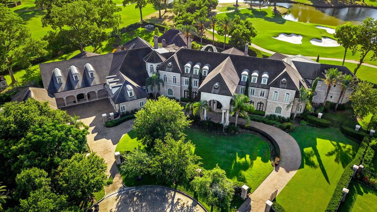 The lavish compound includes two homes, a basketball court, a barbershop and a custom swimming pool with a slide.