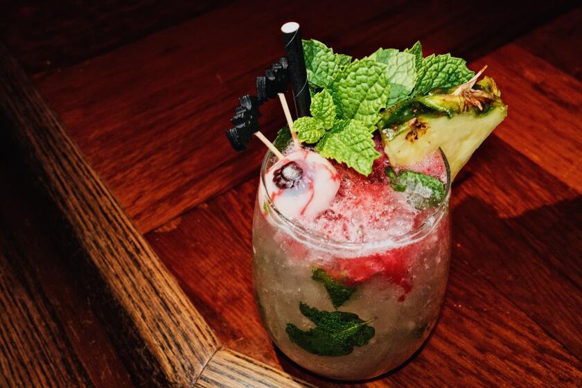 A ocktail garnished with gummy eyeball, mint, pineapple and bat toothpicks at Long Beach Tiki Bar Bamboo Club