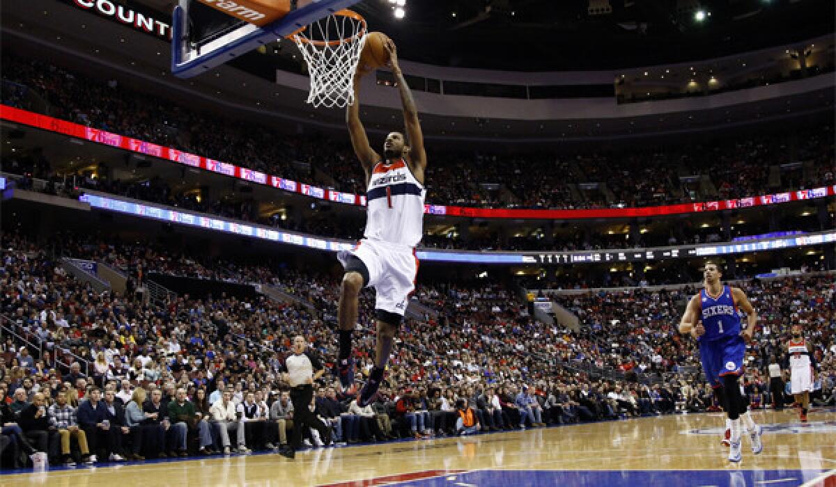 Washington's Trevor Ariza dunks for two of his career-high 40 points Saturday during the Wizards' 122-103 victory over the 76ers in Philadelphia.