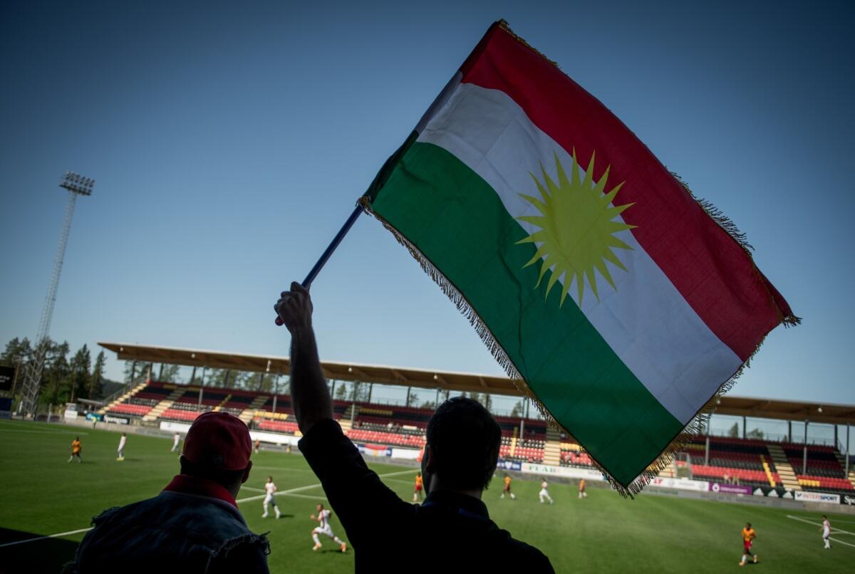 Supporter waves Kurdish flag at soccer game in Sweden in June.