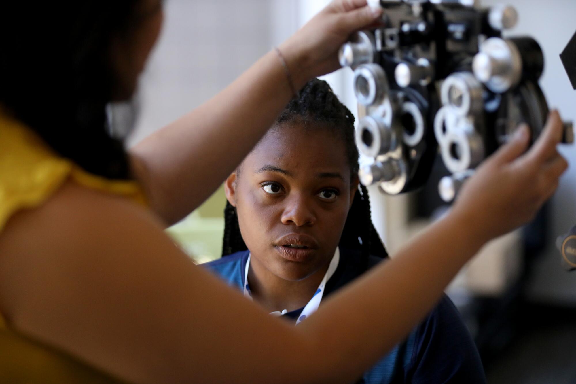 Sienna Jackson receives a free eye exam on the campus Sacramento State University.