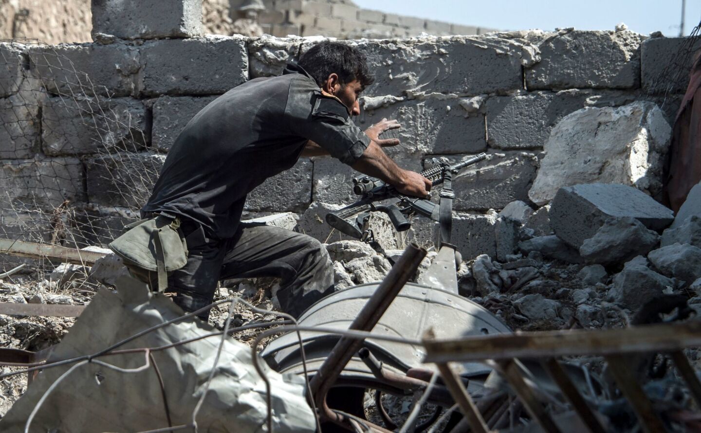 A member of the Iraqi forces walks through the rubble while carrying an M4 assault rifle in the Old City of Mosul on July 10, 2017, during the offensive to retake the embattled city from Islamic State fighters.