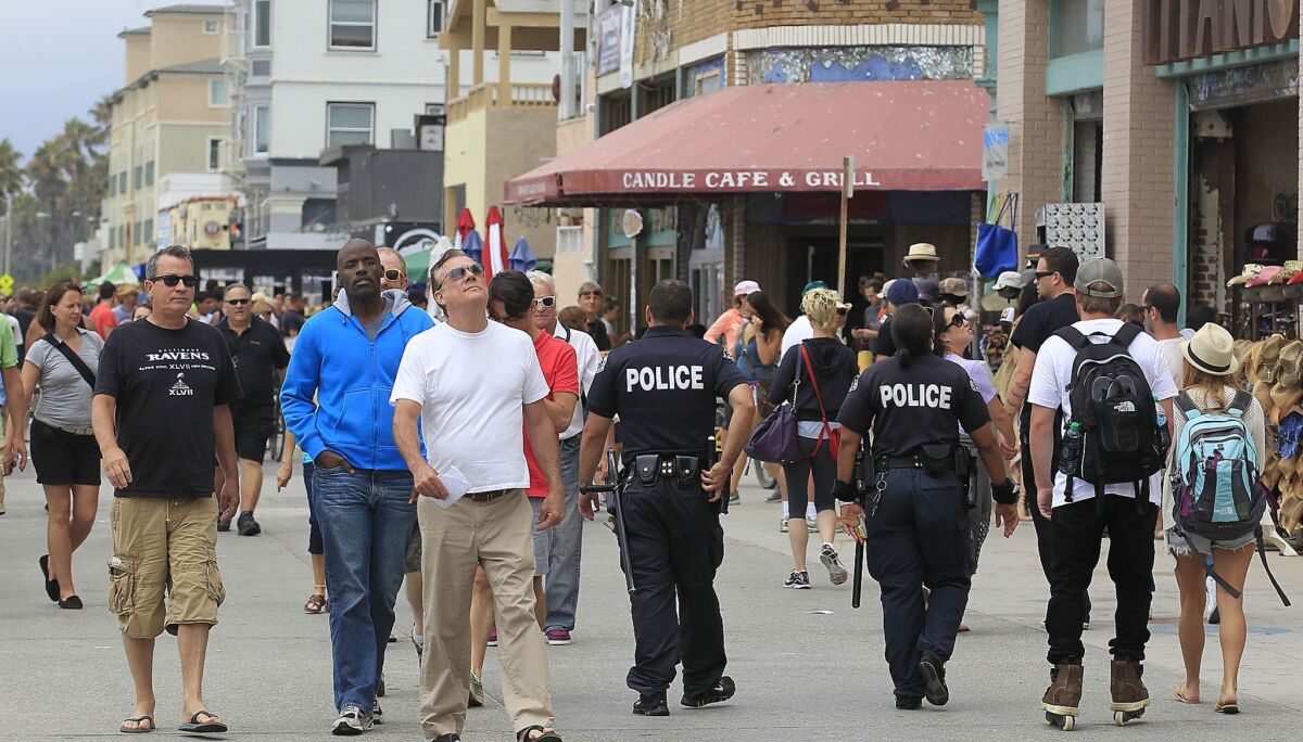 LAPD officers patrol the Venice Boardwalk. 