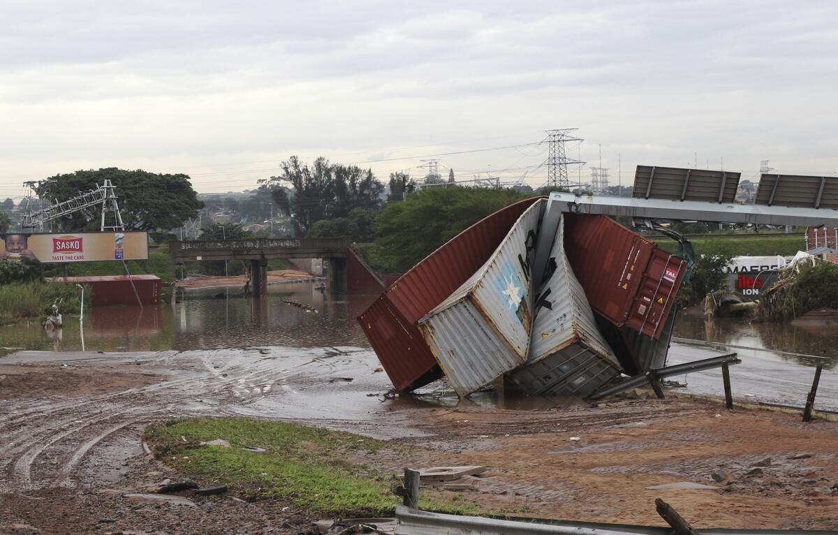 Shipping containers carried away and left in a jumbled pile by floods in Durban.