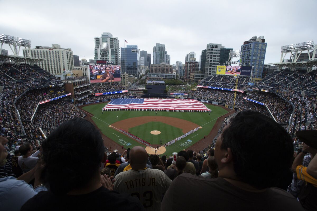 A giant American flag is displayed on the field at Petco Park.