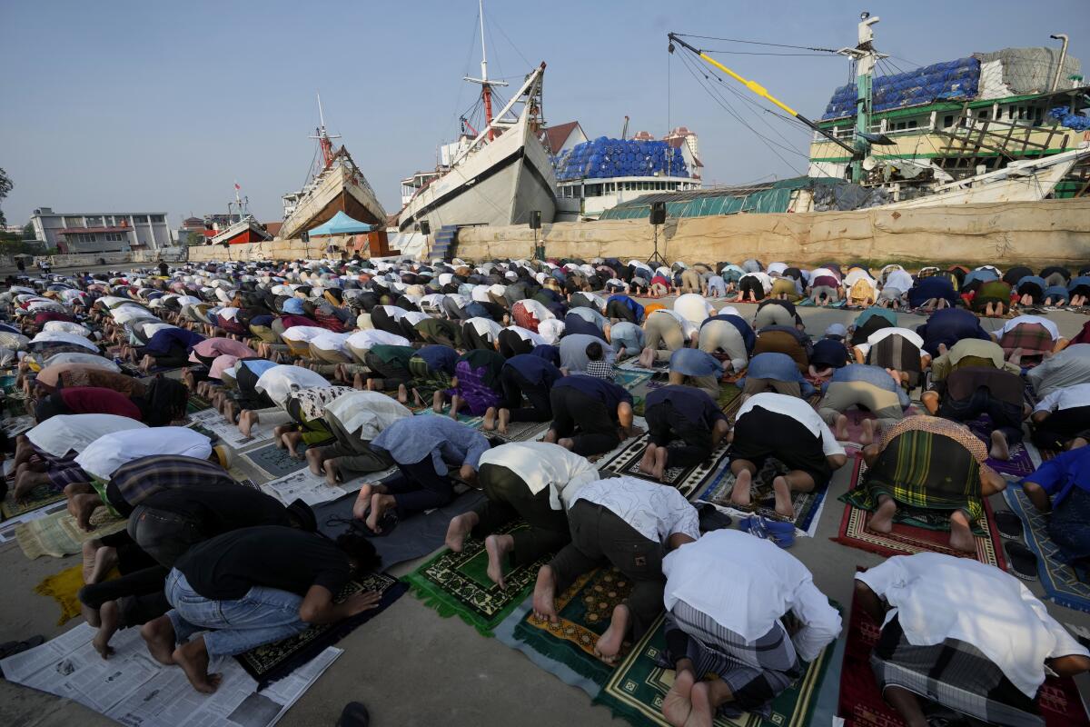 Muslim men praying at a port in Jakarta, Indonesia