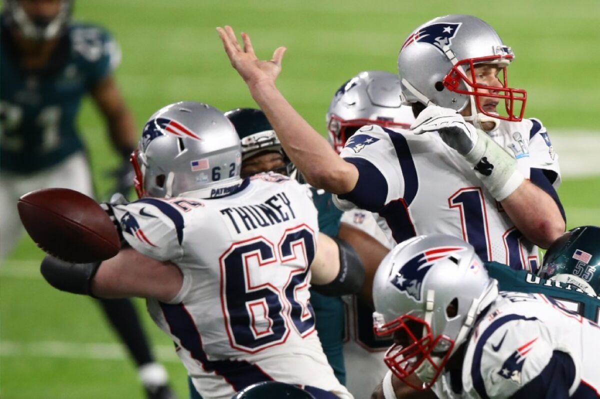 Patriots quarterback Tom Brady (12) fumbles against the Philadelphia Eagles during the fourth quarter in Super Bowl LII.