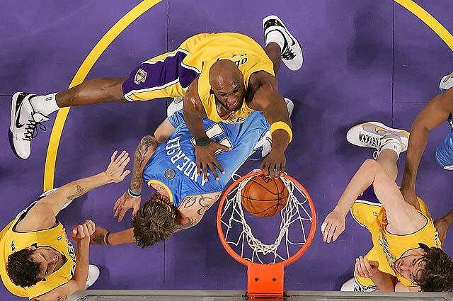 Lakers forward Lamar Odom slams the ball over Nuggets defender Chris Andersen as Los Angeles pulls ahead of Denver late to win Game 5 of the Western Conference Finals at the Staples Center.