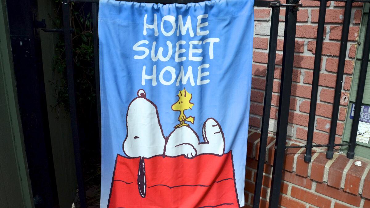A Snoopy flag covers the gate to the Newport Beach cottage where the late Bob Zink built much of his collection of Snoopy and other "Peanuts" memorabilia.