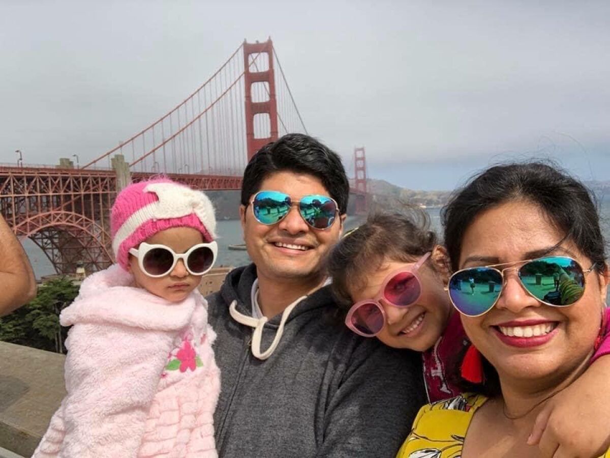 Poorva Dixit and her family pose for a photo in San Francisco, where she and her husband worked prior to being separated.