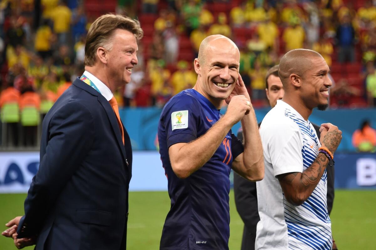 Coach Louis van Gaal, left, and forward Arjen Robben celebrate after the Netherlands' 3-0 victory over Brazil in the World Cup third-place game in July.