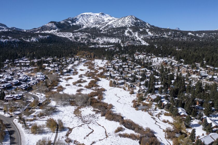 MAMMOTH LAKES, CA - October 27 2021: Aerial view of Mammoth Mountain from above Mammoth Creek on Wednesday, Oct. 27, 2021 in Mammoth Lakes, CA. The ski resort will open two weeks earlier than scheduled thanks to recent snow storms. (Brian van der Brug / Los Angeles Times)