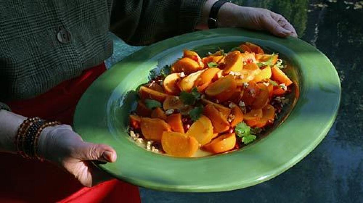 Fuyu persimmons with cumin-lime dressing and pomegranates.