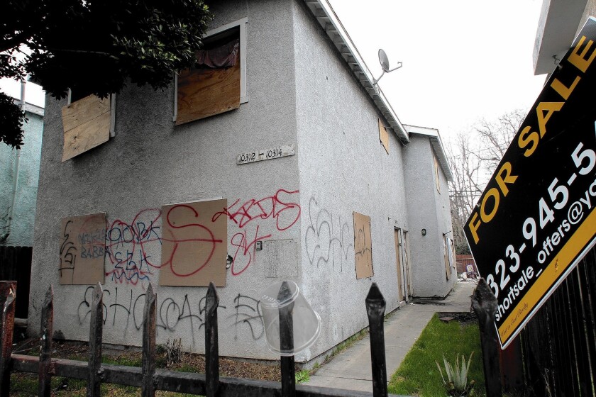 The crimes of a former Bank of America employee involved short sales, which allow troubled borrowers to satisfy their mortgage debts by selling the property for less than they owed. Above, a foreclosed home in L.A. last year.