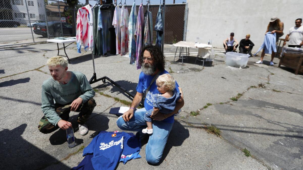 Reese Cooper, left, with Harry Bernstein and Bernstein's 1-year-old son Leo at Cooper's May 4 arts and crafts event in Glassell Park.