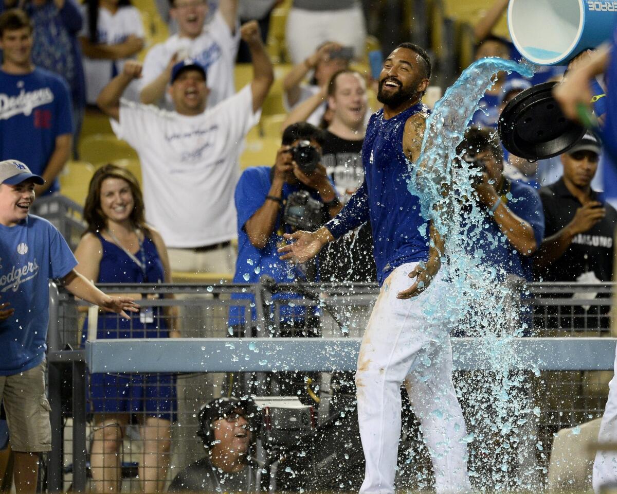 Dodgers outfielder Matt Kemp is doused with sports drink after his game-winning single in the bottom of the 10th inning against Atlanta on Wednesday night.
