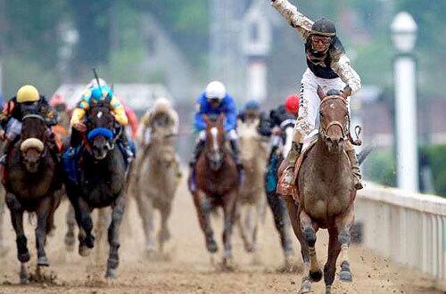 Jockey Calvin Borel begins to celebrate as Mine That Bird nears the finish line in winning the 135th Kentucky Derby at Churchill Downs on Saturday.